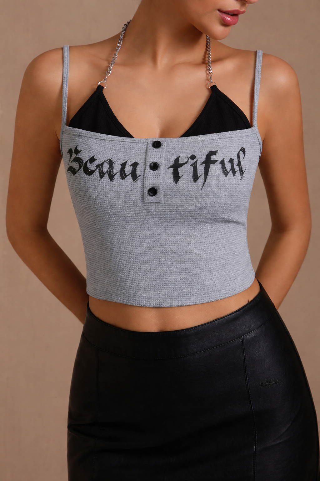 Woman wearing a gray tank top with 'Beau tiful' text on a beige background