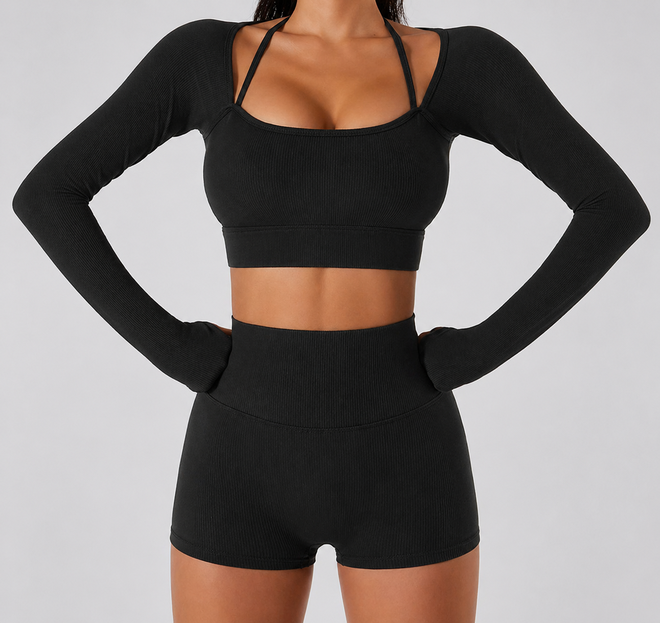 Person wearing a black athletic outfit on a gray background