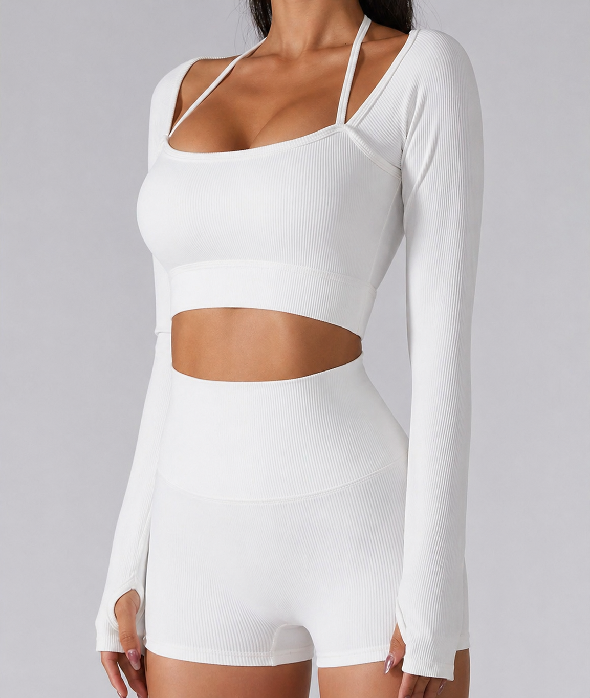White long-sleeve crop top and shorts set on a gray background