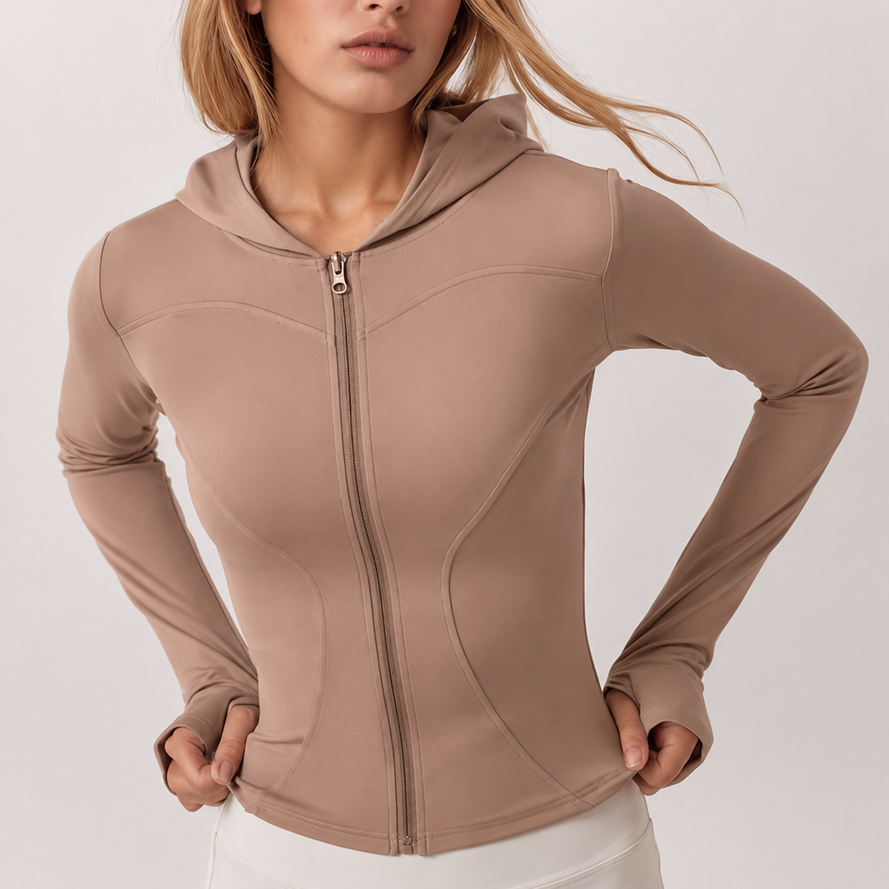 Beige hoodie worn by a person on a light gray background