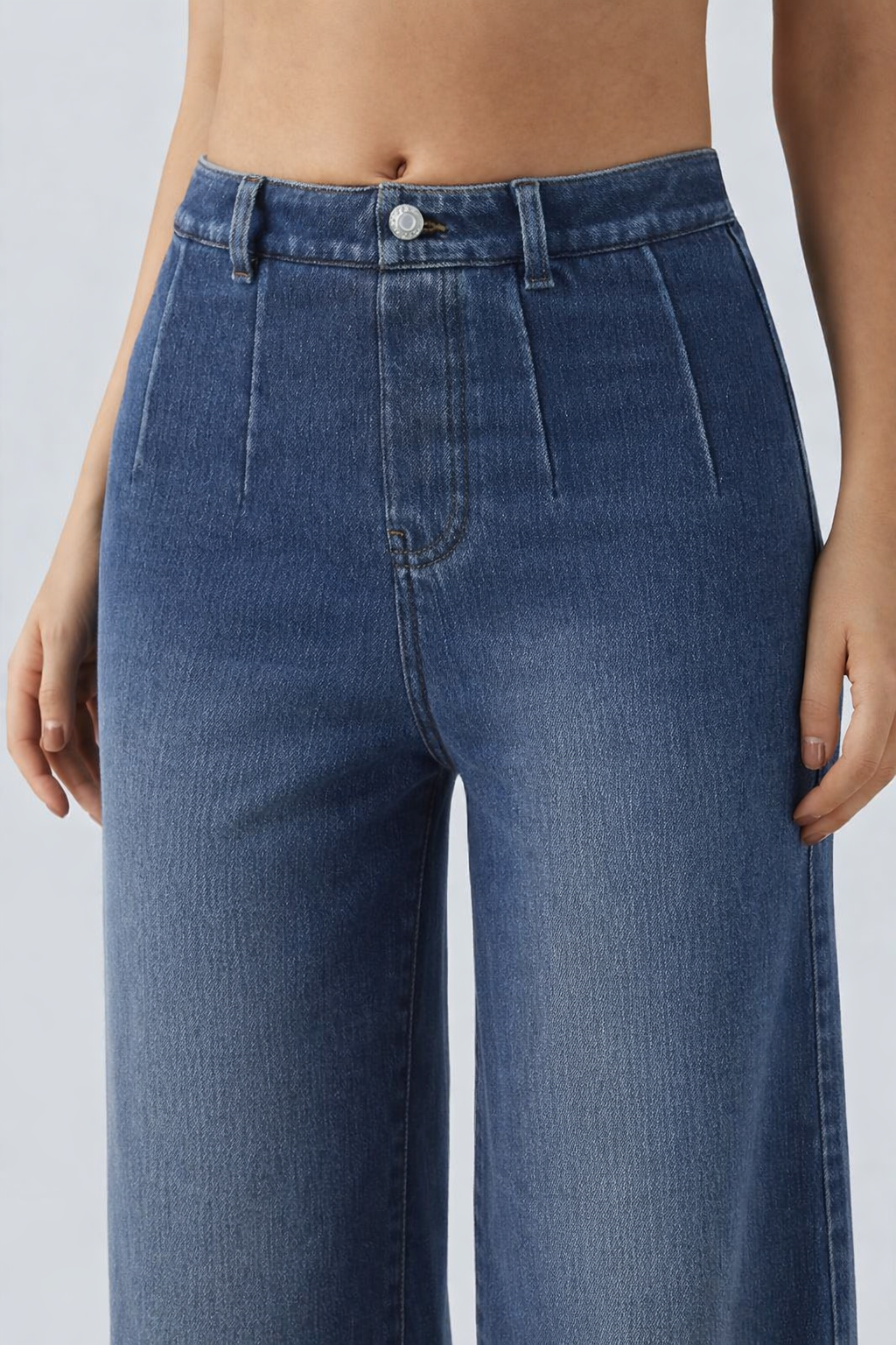 Blue jeans worn by a person on a white background