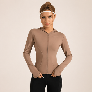 Woman wearing a beige zip-up hoodie on a beige background