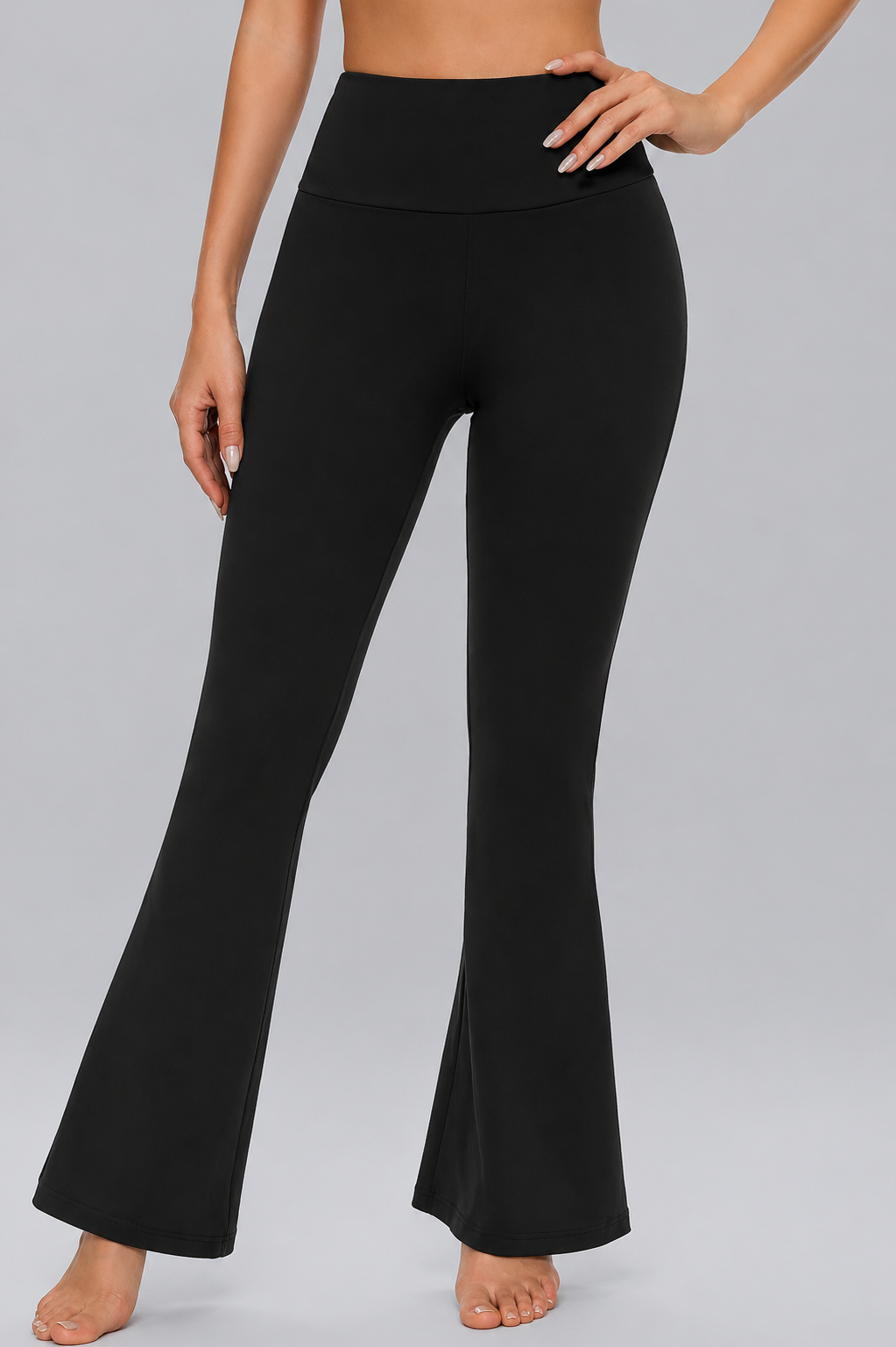 Black flared pants worn by a person on a gray background
