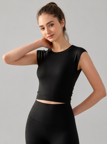 Woman wearing a black athletic outfit on a gray background