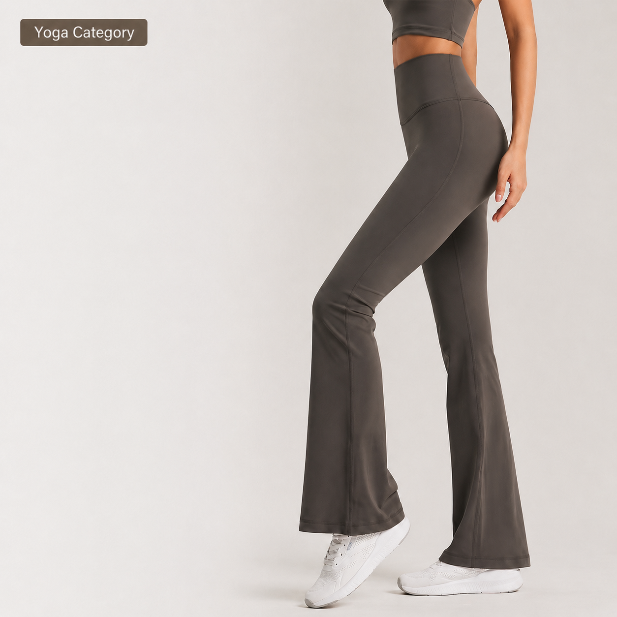 Dark gray yoga pants worn by a person on a light gray background