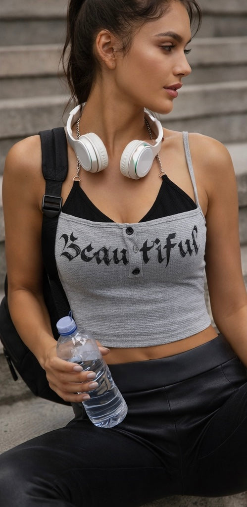Woman wearing a tank top with the word 'Beautiful' holding a water bottle and headphones.