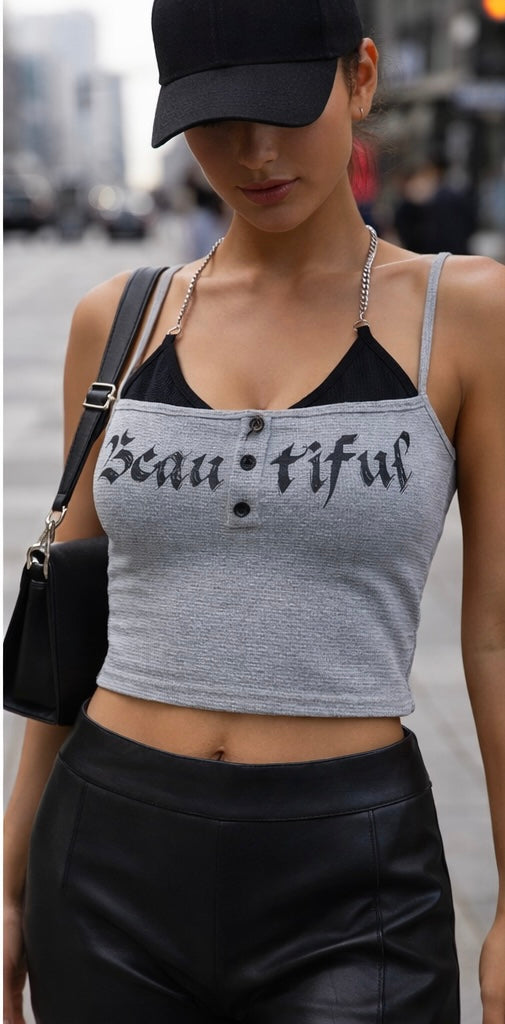 Person wearing a tank top with 'Beautiful' text on a blurred street background