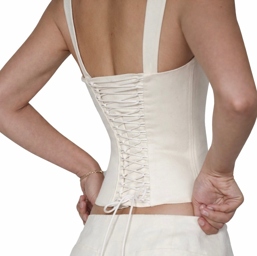 White corset top with thin straps on a white background