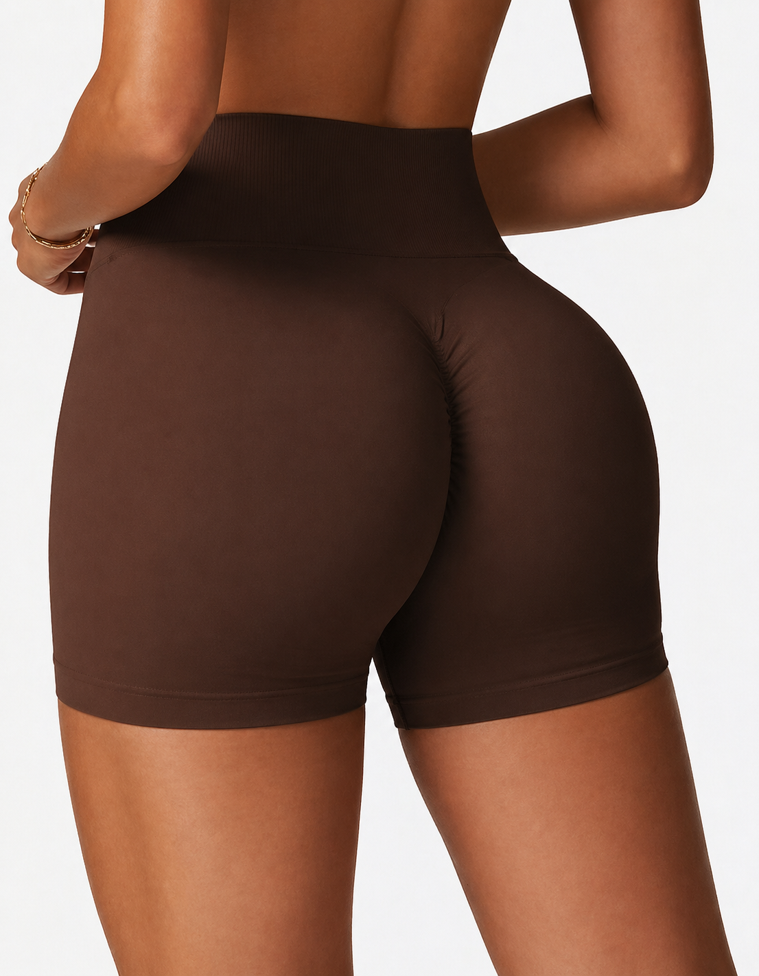 Brown high-waisted shorts worn by a person on a plain background