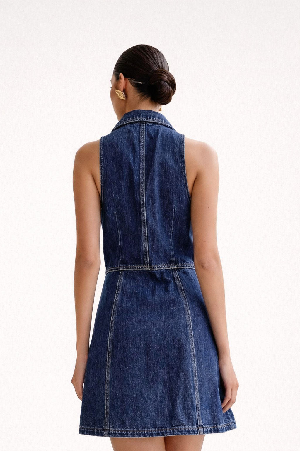 Woman wearing a denim dress on a white background