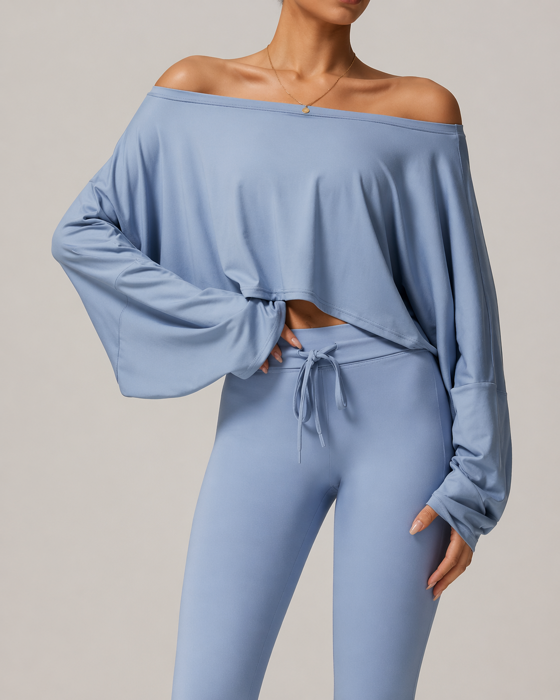 Light blue off-shoulder top and leggings set on a neutral background