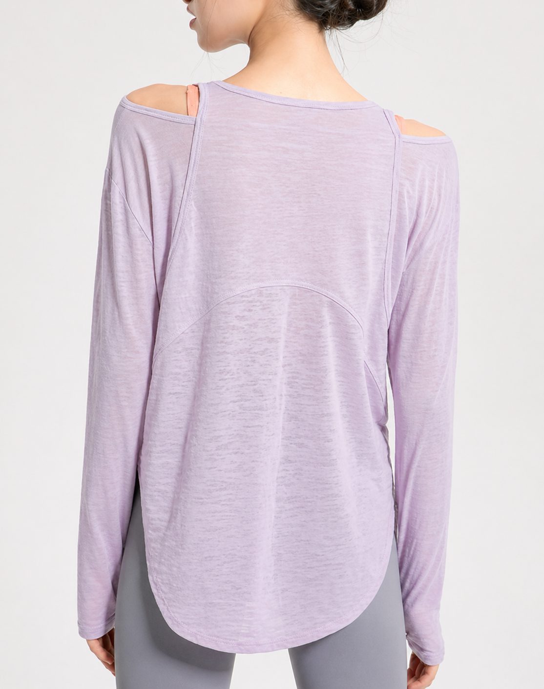 Lavender long-sleeve top worn by a person on a light gray background