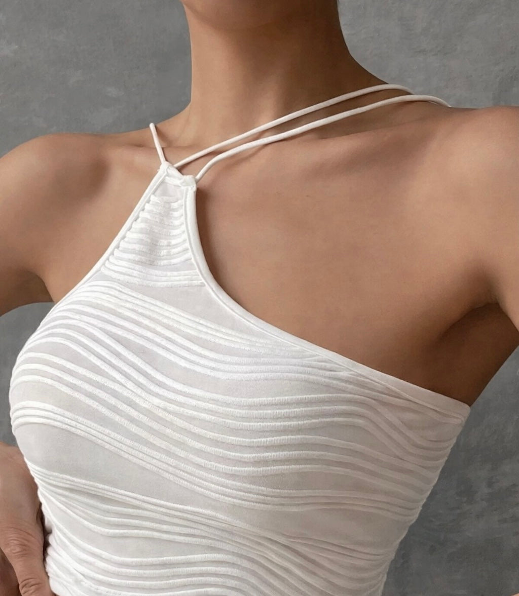 White halter top worn by a model against a gray background
