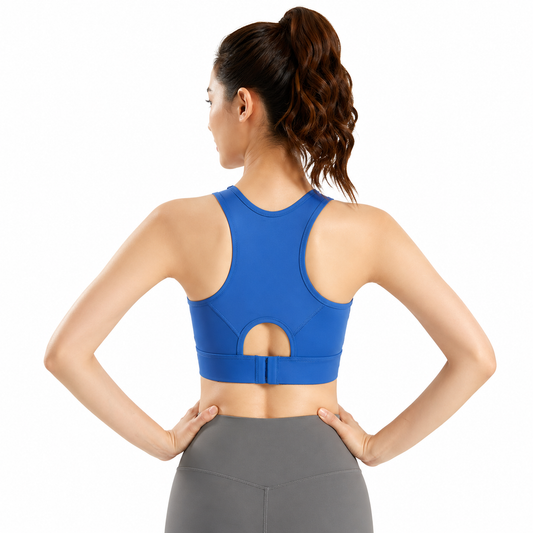 Woman wearing a blue sports bra and gray leggings on a white background