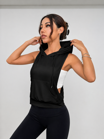 Woman wearing a black sleeveless hoodie against a white background