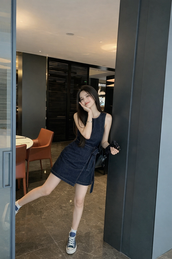Woman in a black dress standing in a modern interior setting