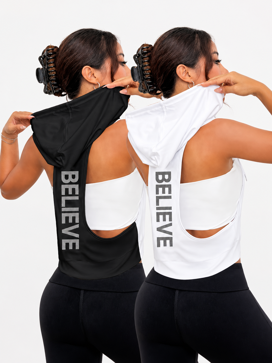 Two women wearing black and white tank tops with 'BELIEVE' text on the back against a light gray background.