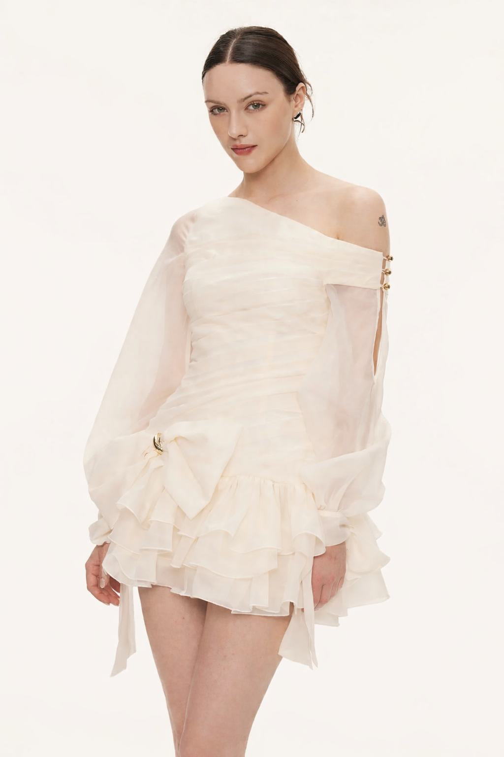 Woman wearing a white off-shoulder dress on a white background