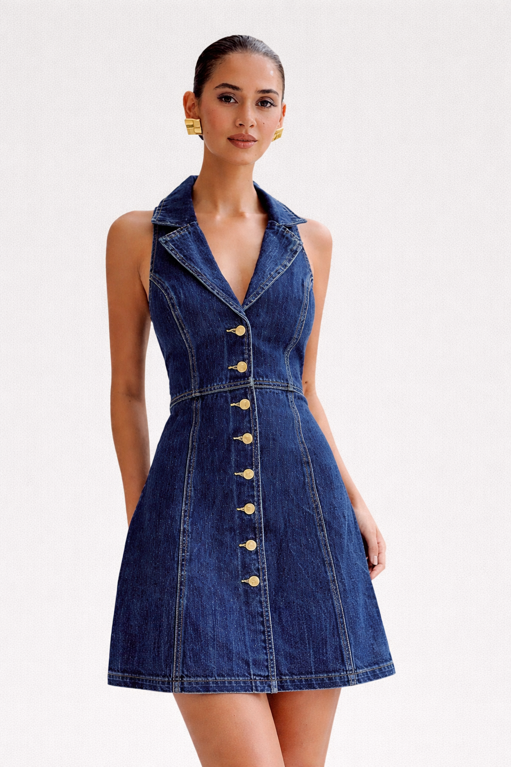 Woman wearing a denim dress with a white background