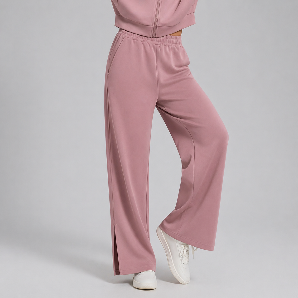 Pink tracksuit with wide-leg pants on a gray background
