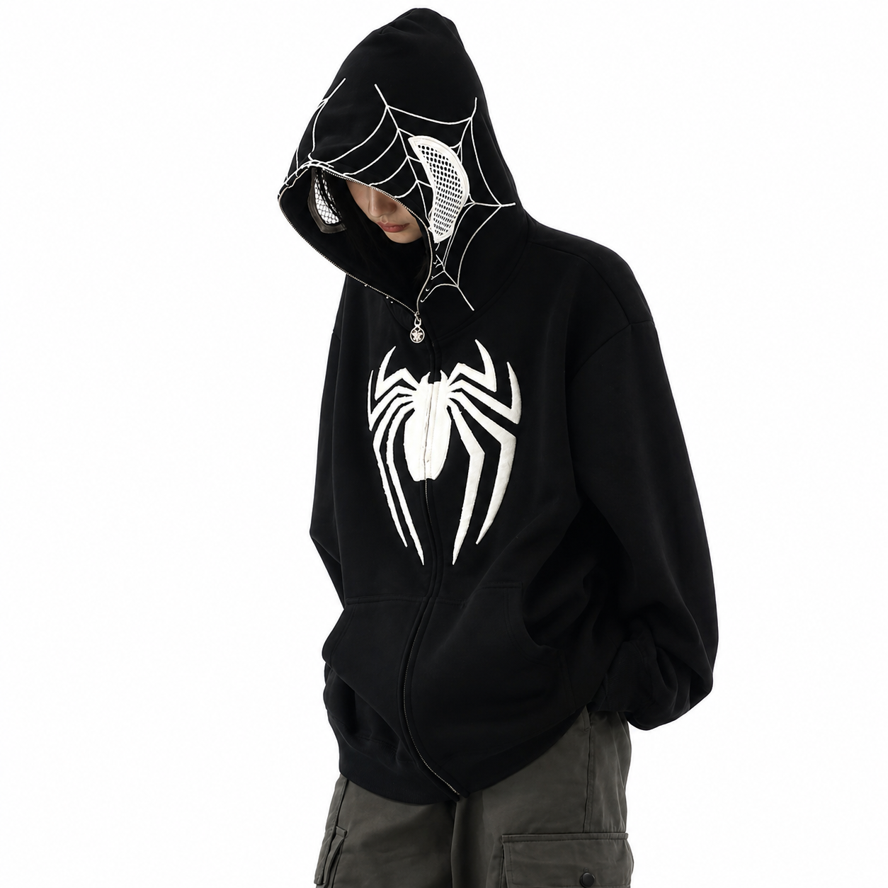 Person wearing a black hoodie with a spider logo on a white background
