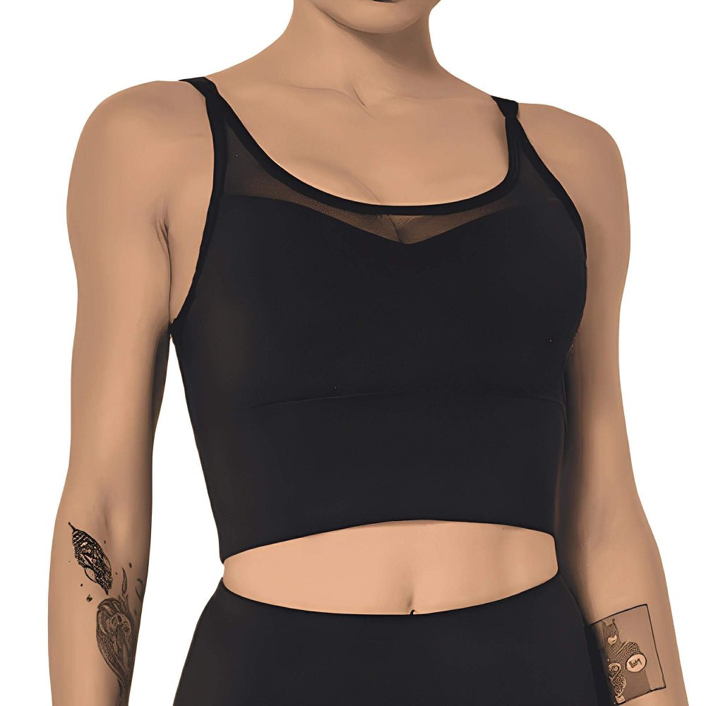 Black sports bra worn by a person on a white background