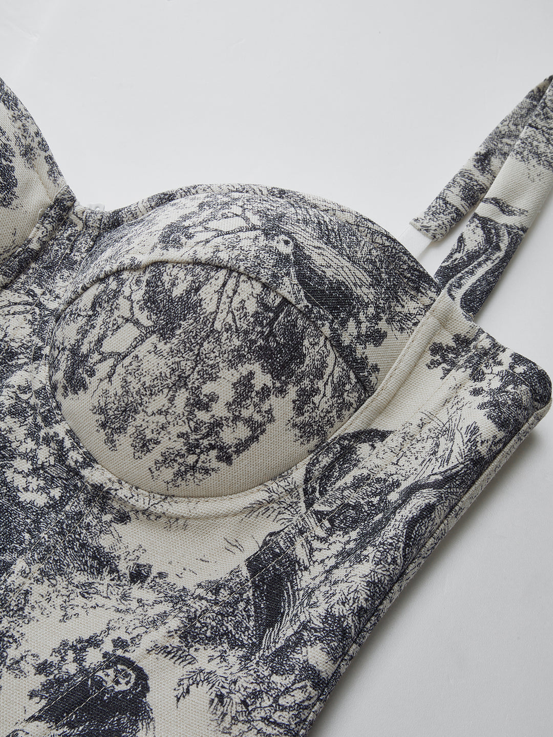 Black and white patterned fabric with a floral design on a white background