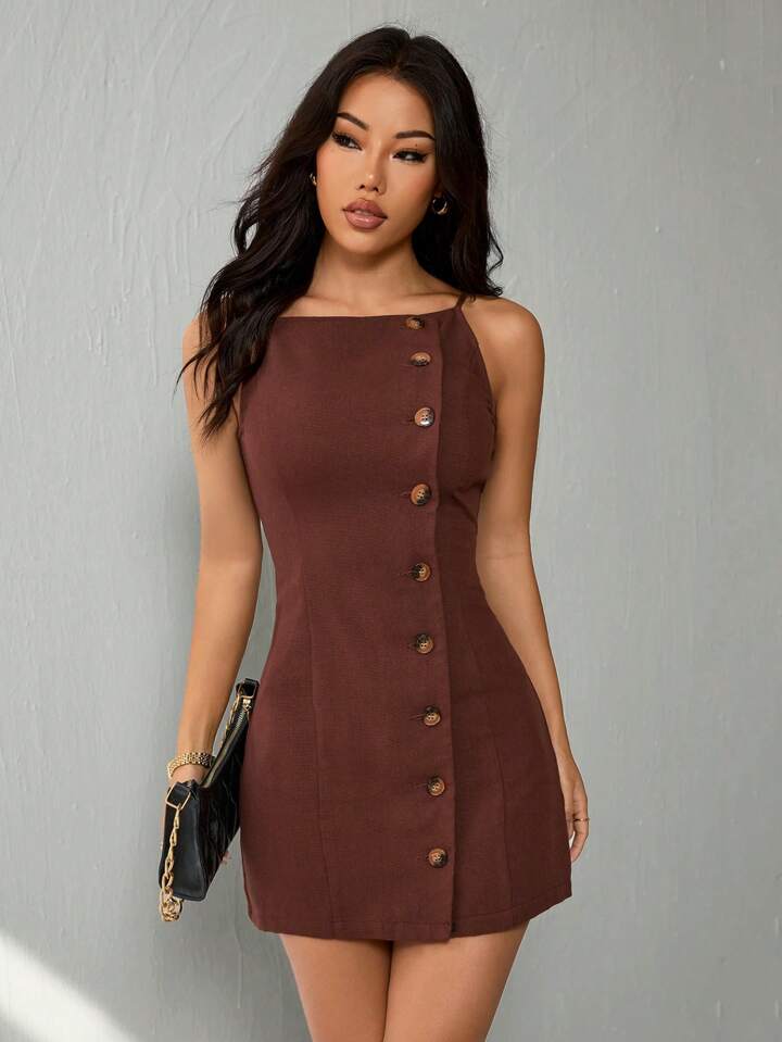 Woman wearing a brown dress with buttons against a gray background