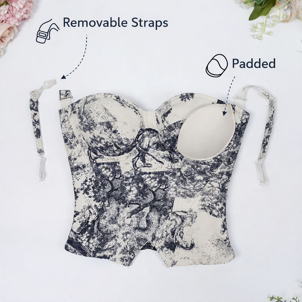 Floral-patterned baby carrier with removable straps and padding on a white background