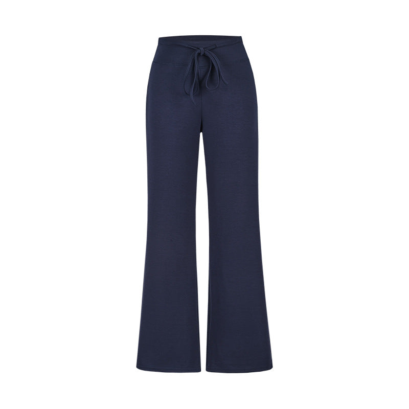 Navy blue wide-leg pants with a tie waist on a white background