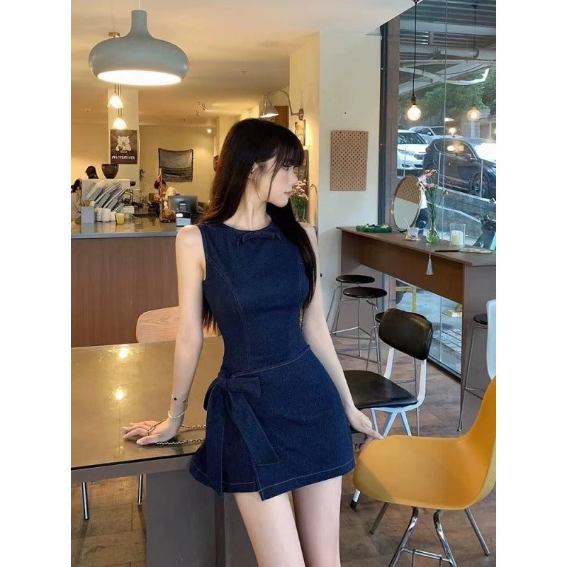 Woman in a blue dress standing in a cafe.